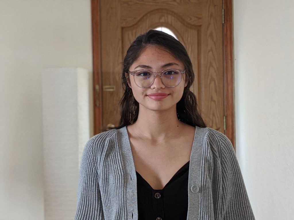 girl smiling in front of the door