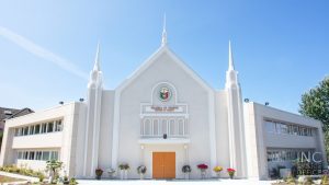 The freshly renovated Iglesia Ni Cristo worship building in Surrey, BC with its newly added steeples, brightly lit by the afternoon sun.