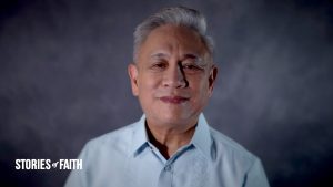 Man with white hair smiling